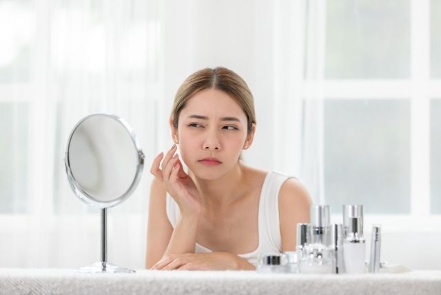 a woman using sunscreen suitable for dry skin